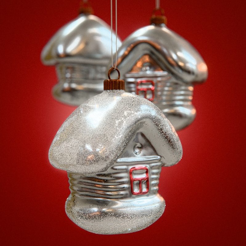 Three silver house christmas ornaments hanging